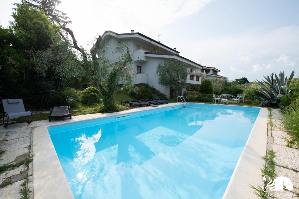 a swimming pool in front of a house at Villa Solelago Exclusive in Lonato