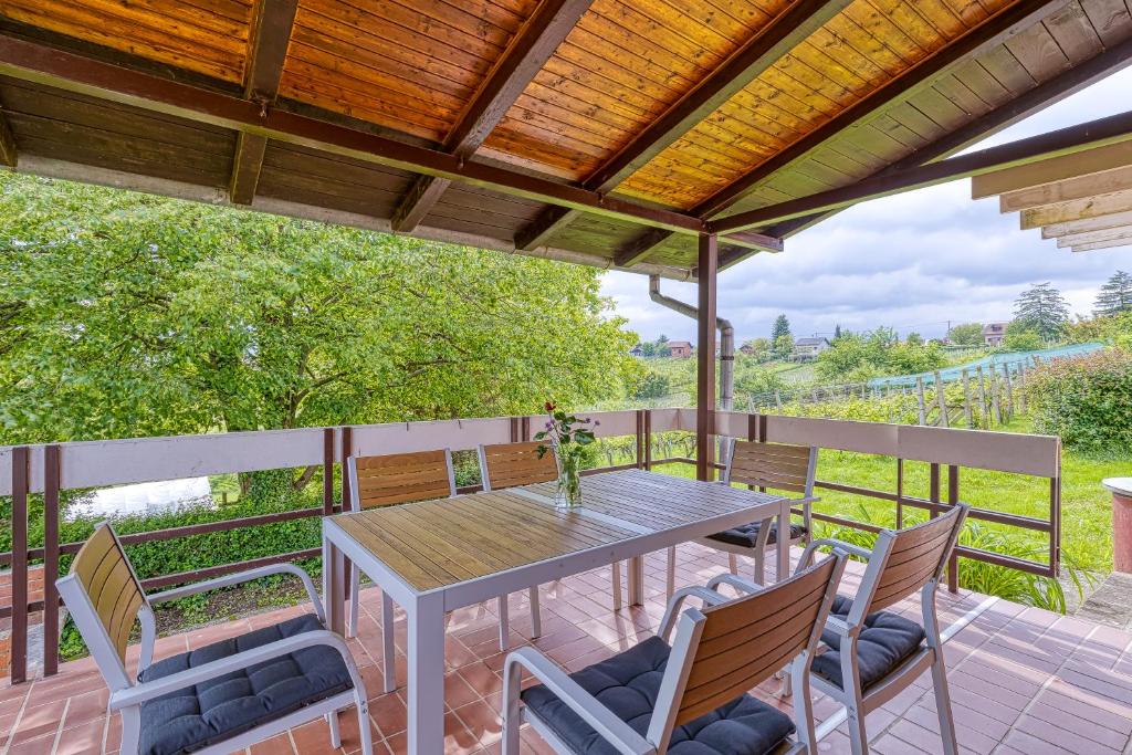 a patio with a table and chairs on a deck at Lovely House Near Zagreb With Terrace - Happy Rentals in Graberje Ivanićko