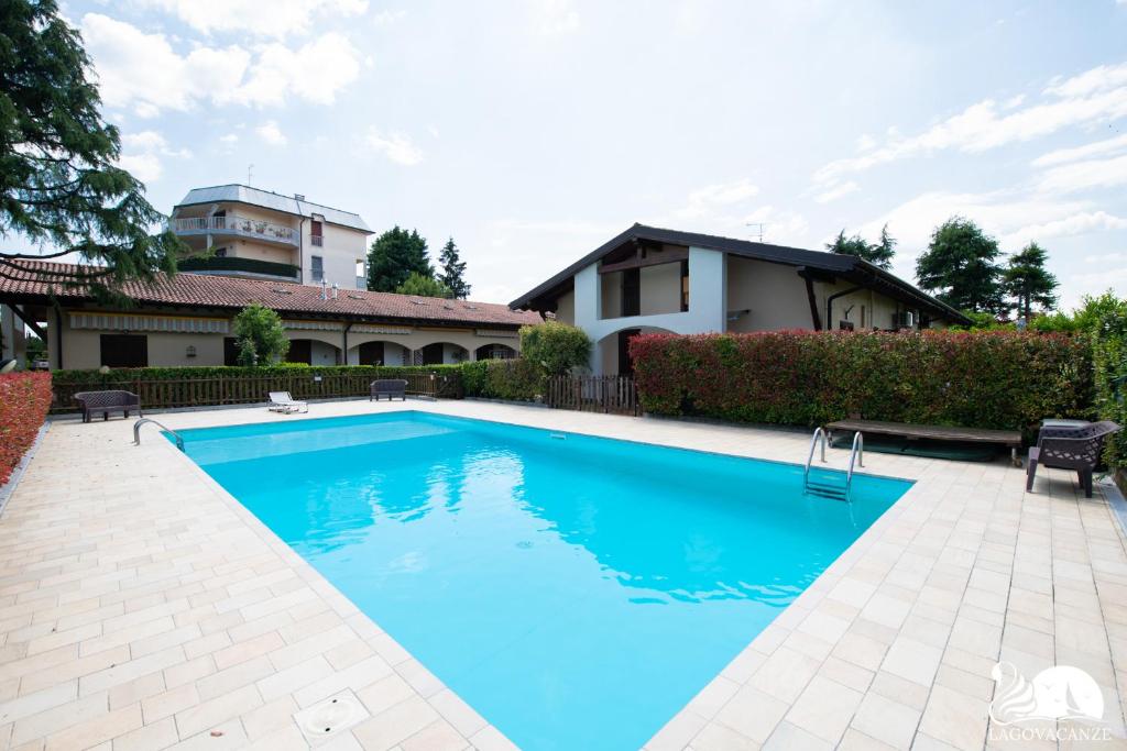 a swimming pool in front of a house at The Three Moons Apartment in Peschiera del Garda