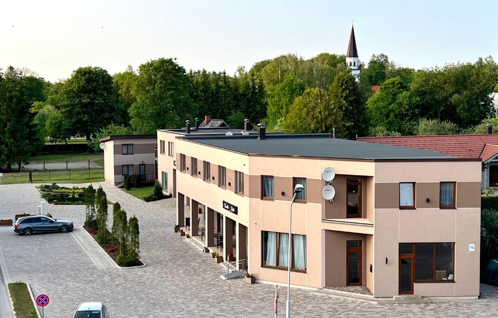 a building with a car parked in a parking lot at Villa Vanilla in Sigulda