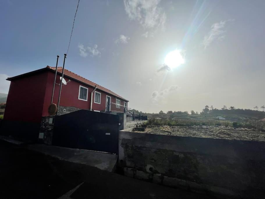a red house with the sun in the sky at Casa Rustica da Maloeira in Malseira