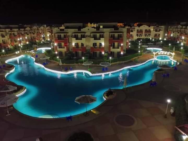 a large swimming pool at a resort at night at قريه لاسرينا العين السخنة in Ain Sokhna