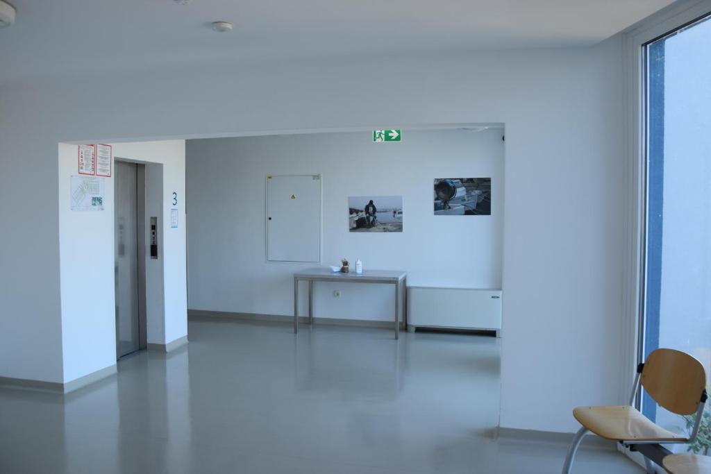 a white room with two chairs and a table at Dijaški dom Portorož, hostel in Portorož