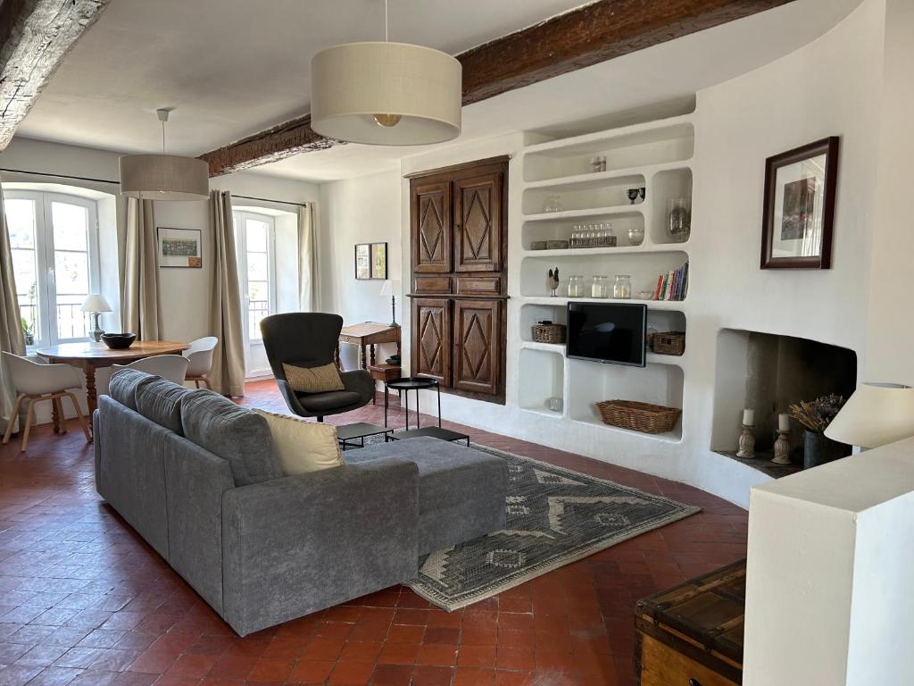 a living room with a couch and a fireplace at Sur le Pont in Vaison-la-Romaine