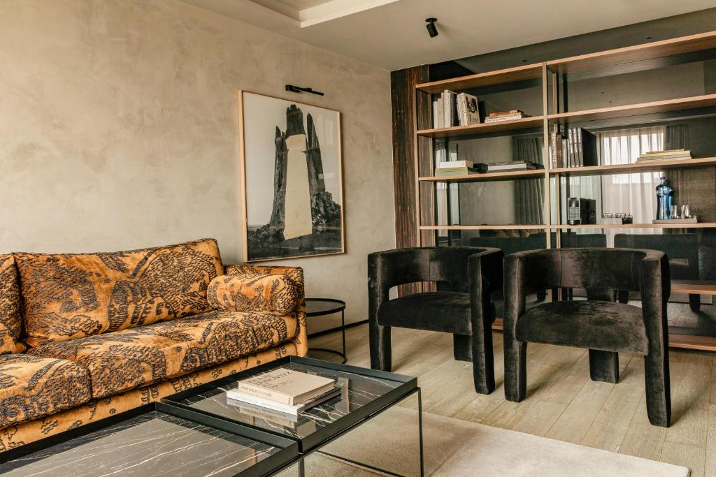 a living room with a couch and two chairs at Hotel Bagués, a Small Luxury Hotel of the World in Barcelona