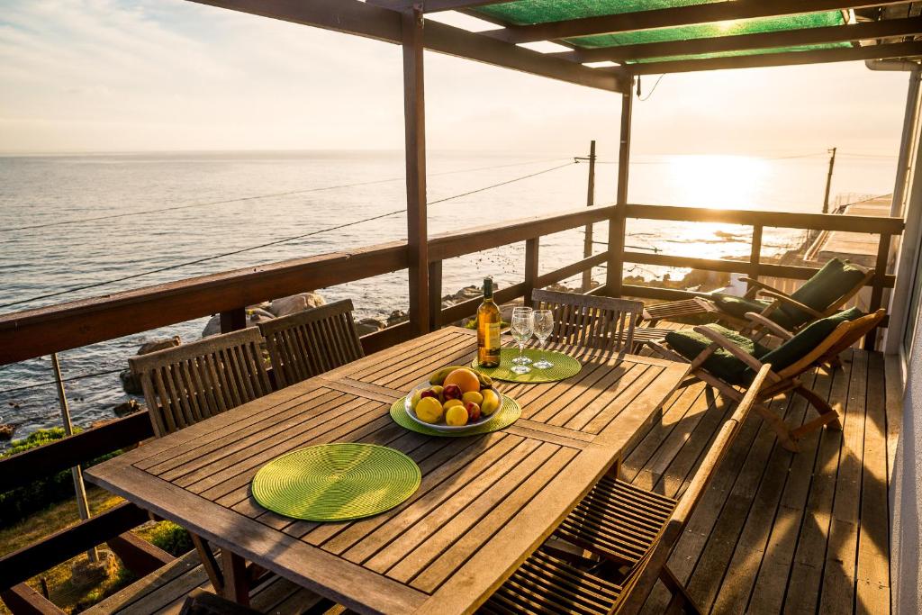 a table on a deck with a bowl of fruit at The Upper Deck at Sunny Cove in Fish hoek