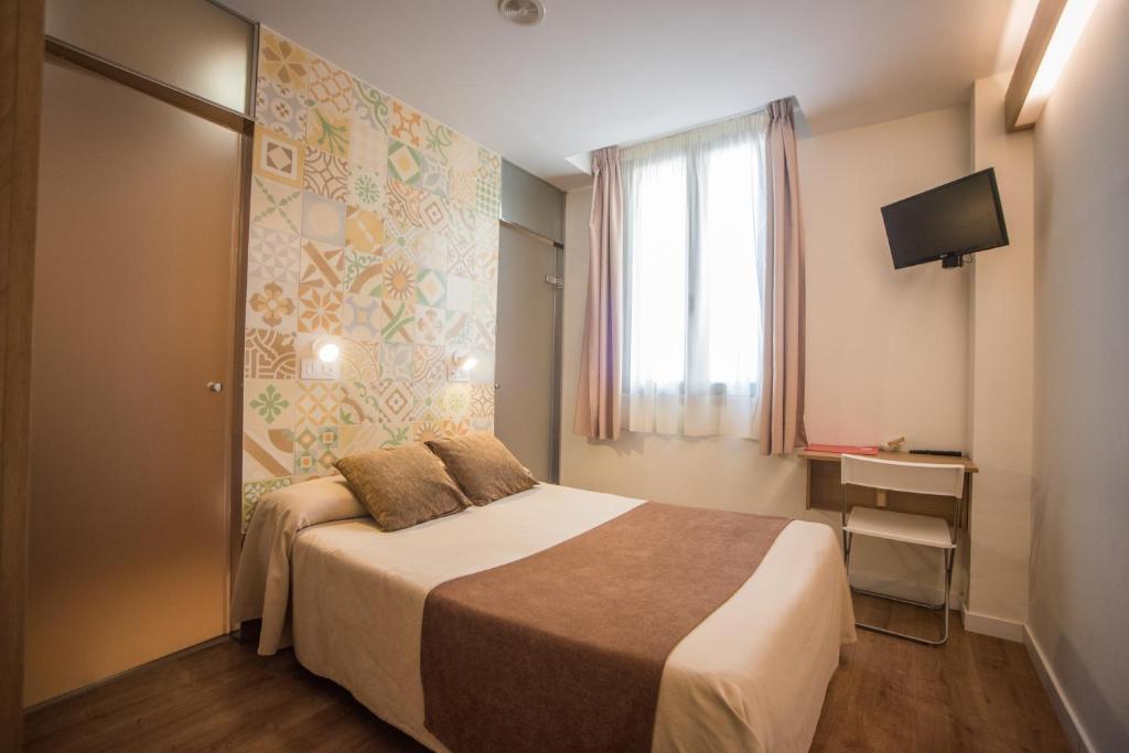 Postel nebo postele na pokoji v ubytování Hostal Marenostrum