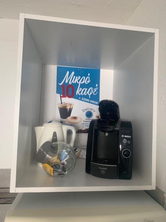 a white shelf with a microwave and a coffee maker at LE DEPOT appartement du port à Champvert in Champvert