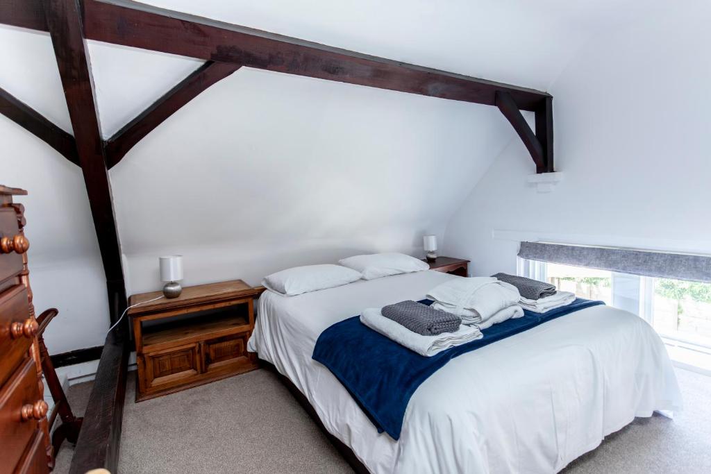 a bedroom with a bed and a large window at The Old Schoolhouse in Whitstable