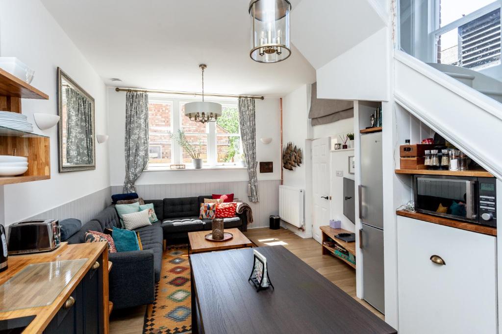 a kitchen and living room with a couch and a table at The Old Schoolhouse in Whitstable