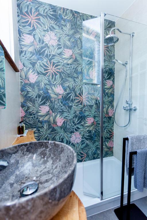 a bathroom with a shower with a stone sink at The Old Schoolhouse in Whitstable