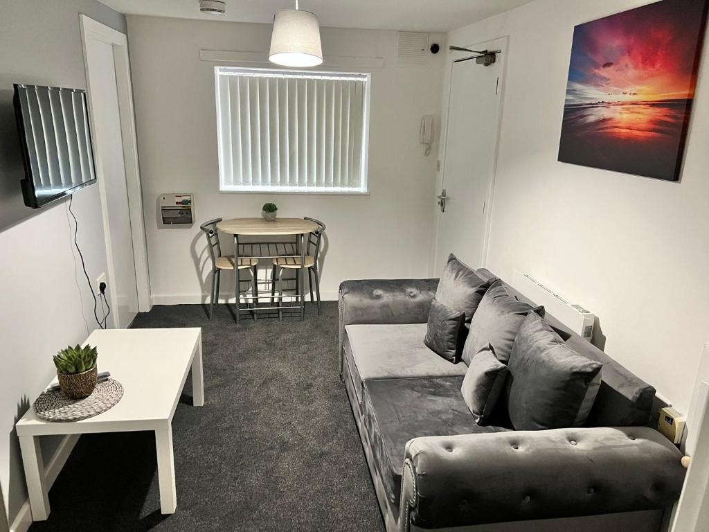 a living room with a couch and a table at Bradford Service accommodation in Bradford