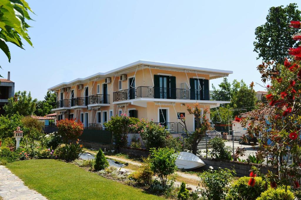 a house with a garden in front of it at EVIA DREAM FAMILY APARTMENTS in Edipsos