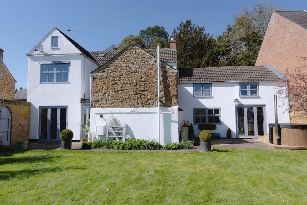 a white house with a grass yard at The Old Sweet Shop, 4 Bedroom House 