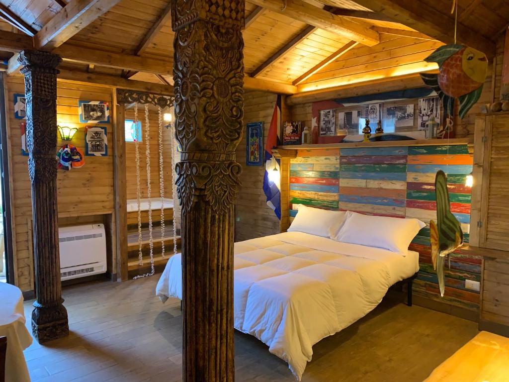 a bedroom with a bed in a wooden room at La Casa di Emanuella - Rooms & International Suites in Bari