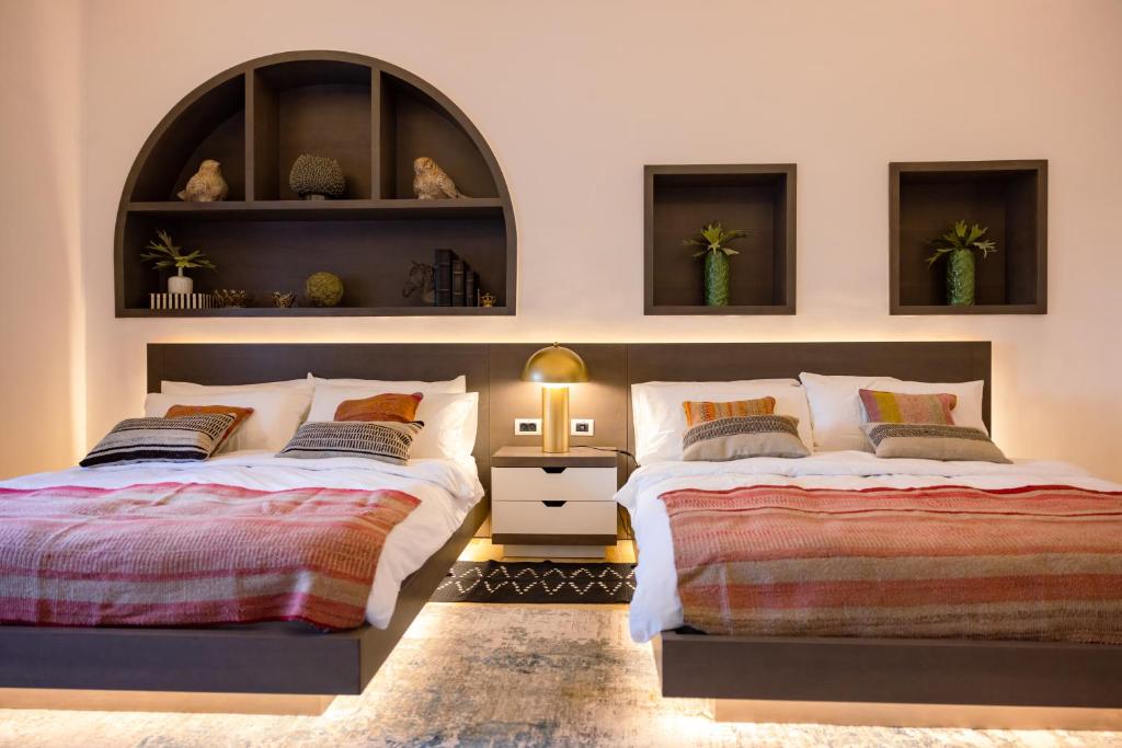 Postel nebo postele na pokoji v ubytování Kassa Boutique Hotel