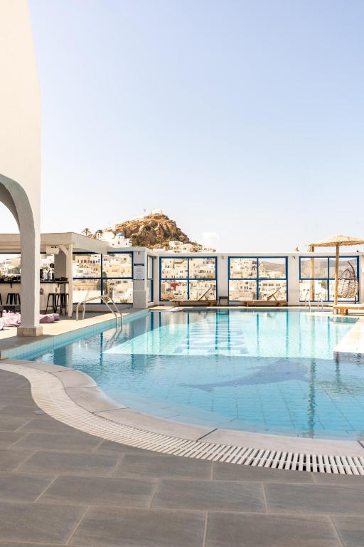 a large swimming pool on top of a building at Sunrise Hotel in Ios Chora