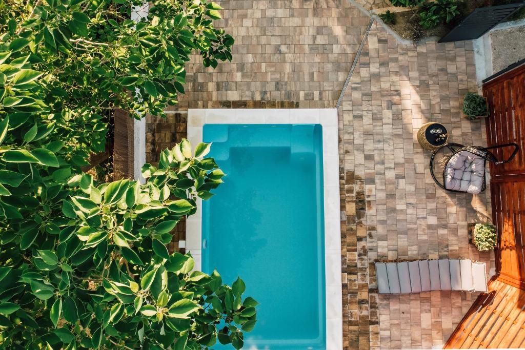 an overhead view of a blue swimming pool in a brick wall at Green & blue in Ražanac