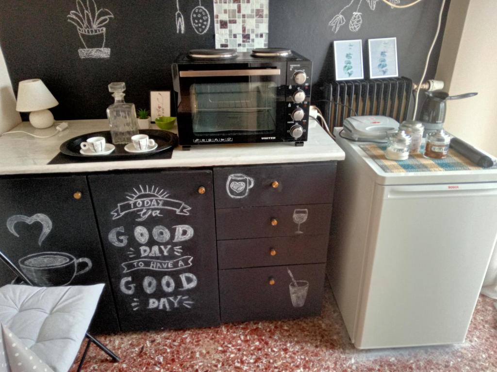 a kitchen with a microwave on top of a dresser at Comfy Studio in Lamía