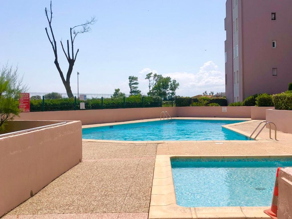 a swimming pool in the middle of a building at Apartment Amourêva-1 by Interhome in Cap d'Agde
