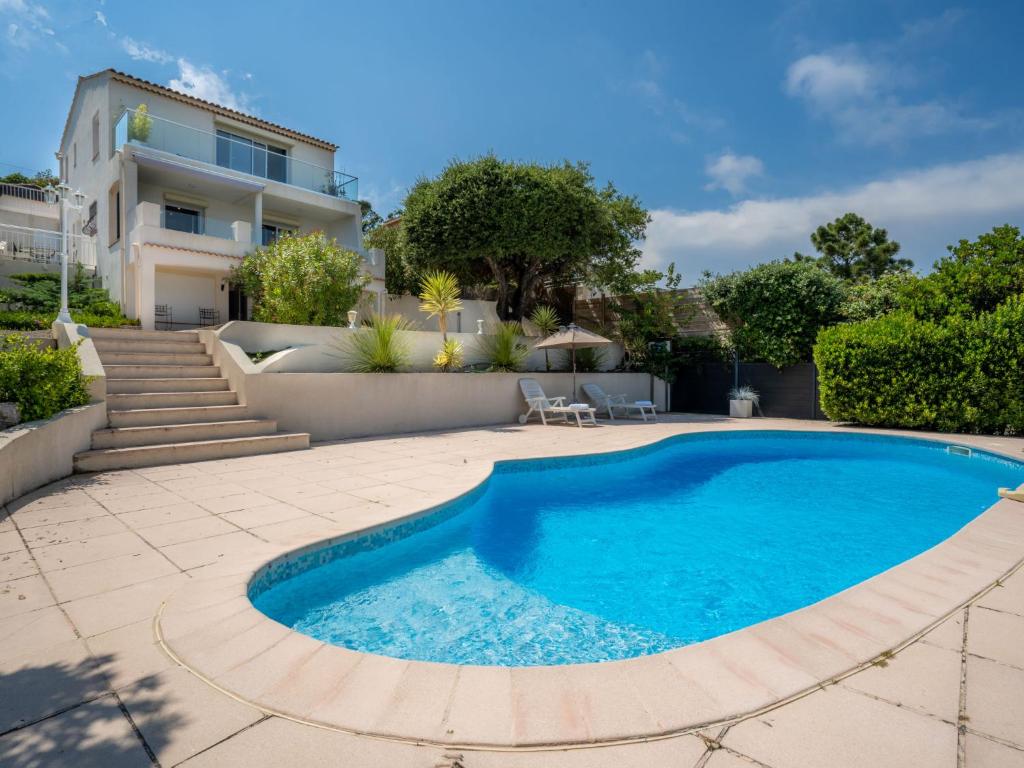 a swimming pool in front of a house at Villa Les 4 Vents by Interhome in Saint-Aygulf