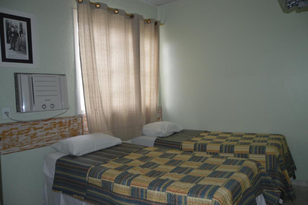 מיטה או מיטות בחדר ב-Hospedagem Belo Horizonte
