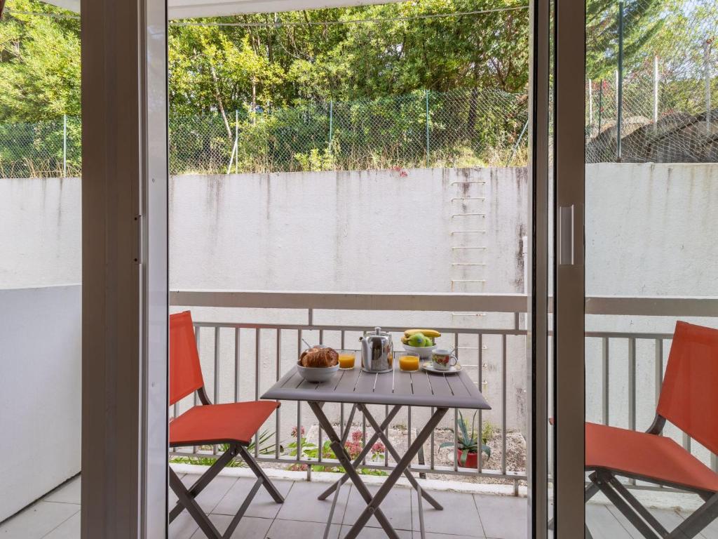 サン・ジャン・ド・リュズにあるApartment Aldapa by Interhomeのテーブル、バルコニー(椅子2脚、フルーツ付)