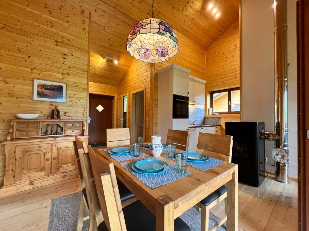 a wooden dining room with a table and chairs at Chalet Stressless by Interhome in Presseggen