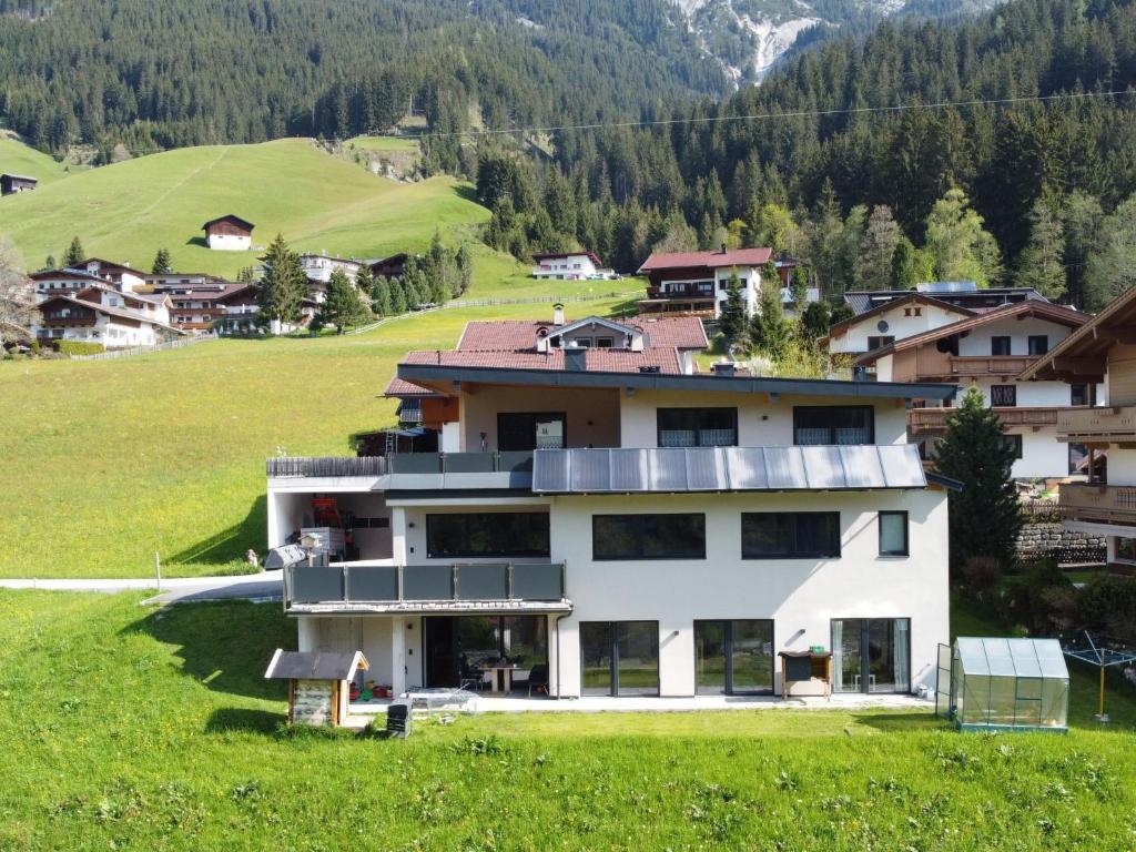 a house in the middle of a green field at Apartment Haus Stock by Interhome in Tux