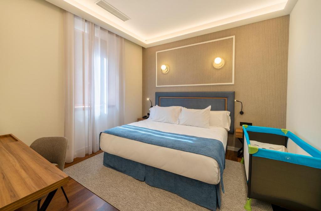 Postel nebo postele na pokoji v ubytování Iberik Gran Balneario de Guitiriz