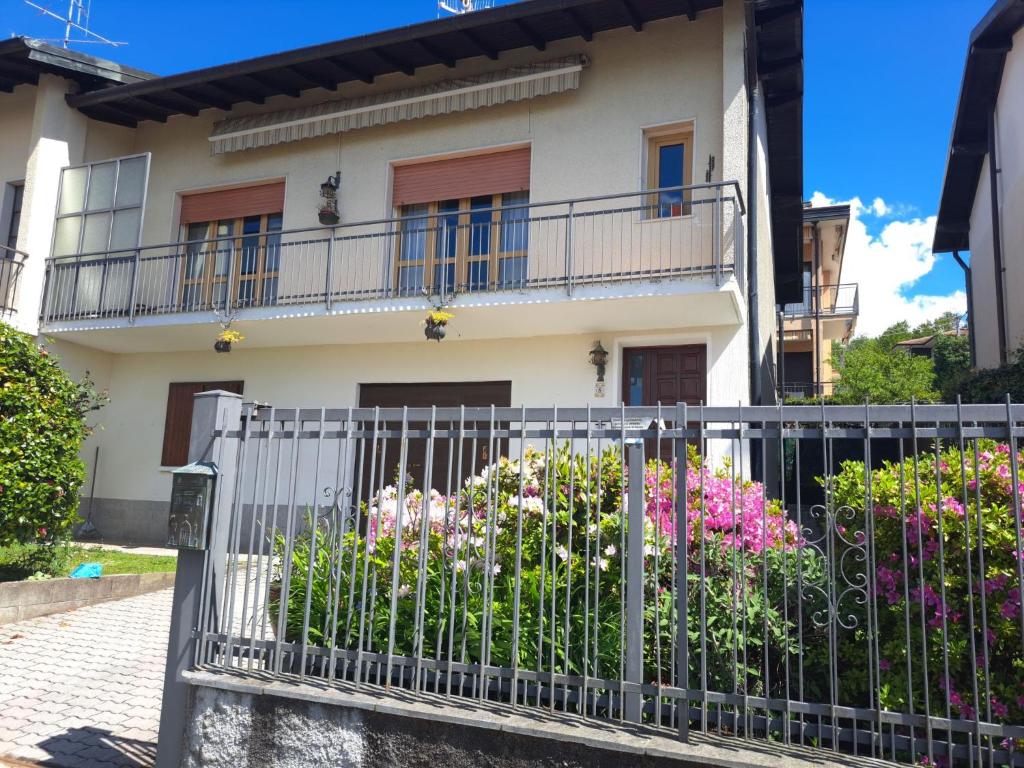 a fence in front of a house with flowers at Holiday Home Bonny by Interhome in Luino