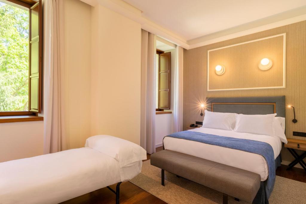 Postel nebo postele na pokoji v ubytování Iberik Gran Balneario de Guitiriz