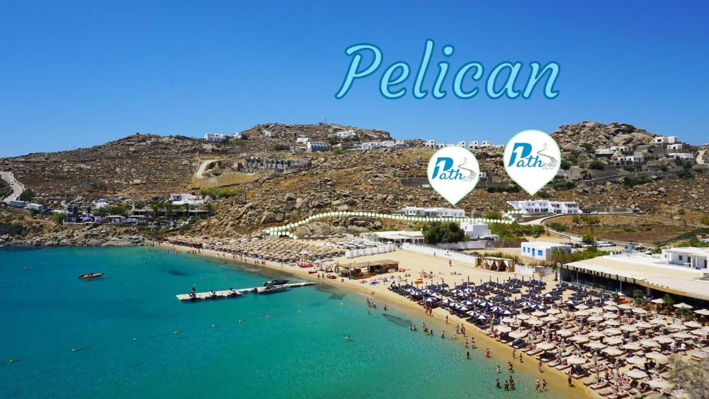 an aerial view of a beach with two hot air balloons at 1Path Pelican Mykonos Super Paradise Beach House in Mýkonos City