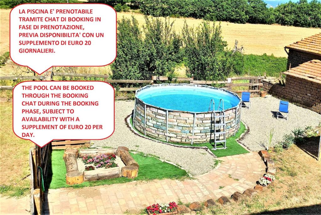 een groot zwembad in een tuin met een bord bij Casavacanze Pergolino con piscina ad uso esclusivo in Acquapendente