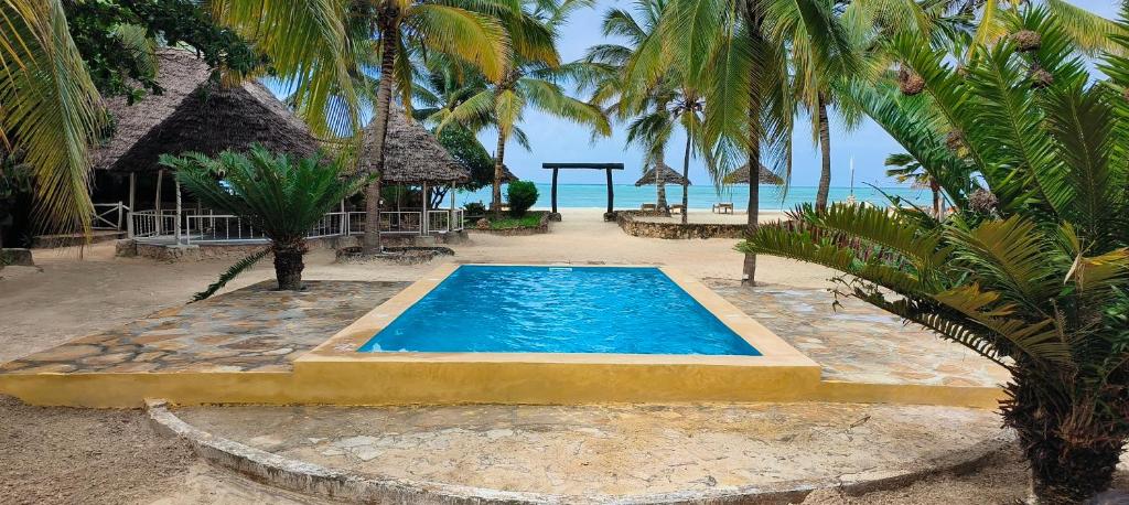 a swimming pool in the middle of a resort at Mambo Ocean Resort in Pwani Mchangani