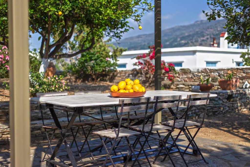 a table with a bowl of fruit on it at Lemoni House in Andros