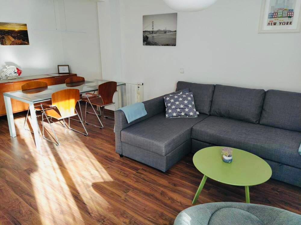 a living room with a couch and a table at August centro Tarragona in Tarragona