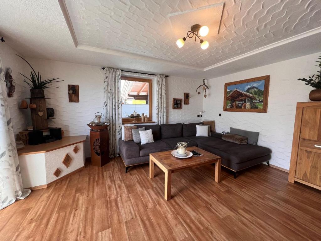 a living room with a couch and a table at Apartment Hüttaler by Interhome in Dorf