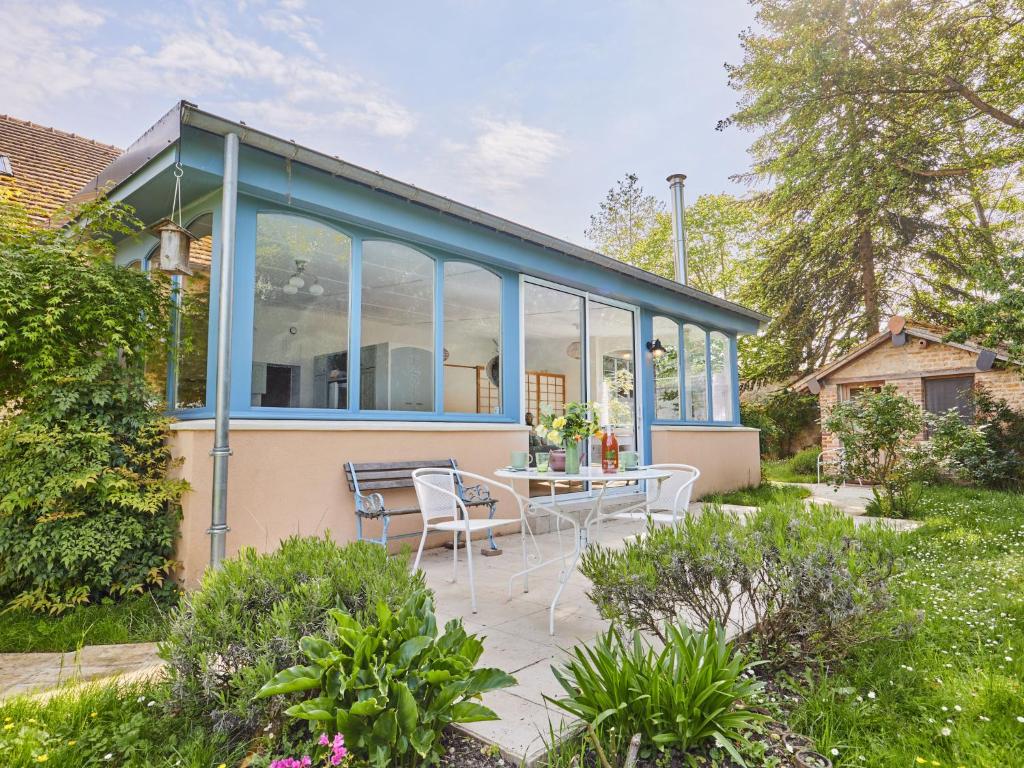 a glass house with a table and chairs in a garden at Studio Le laizon 1 by Interhome in Croissanville
