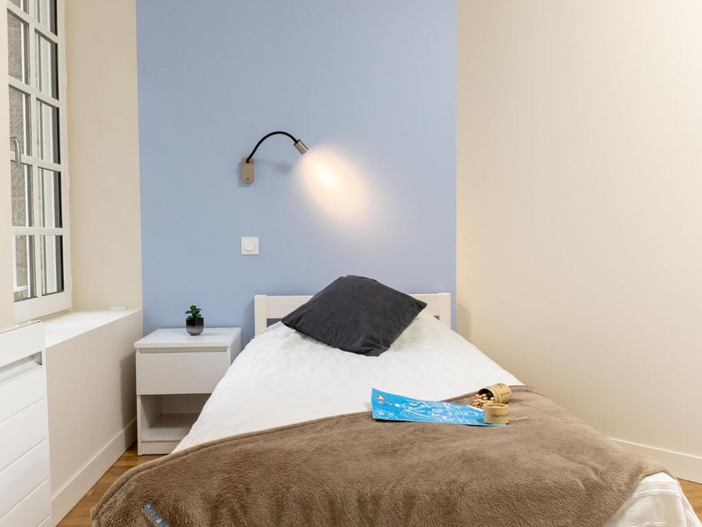 a bedroom with a bed with a bag on it at Apartment Plasenn by Interhome in Saint Malo