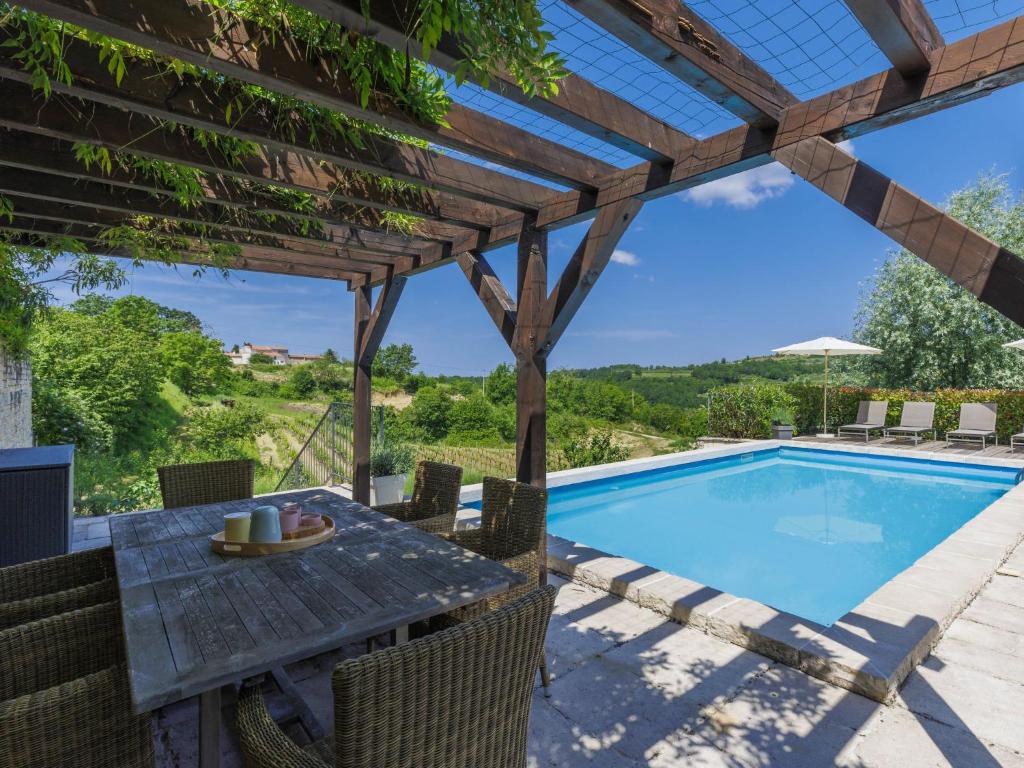 a patio with a table and a swimming pool at Holiday Home Villa Anita by Interhome in Momjan