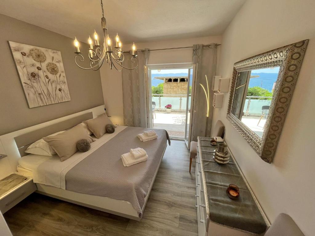a bedroom with a bed and a mirror and a sink at Apartment Merlin in Bol