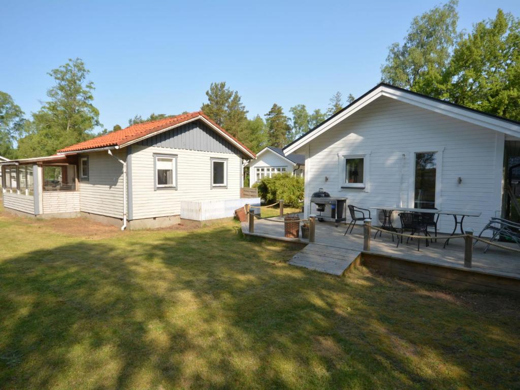 a white house with a patio and a yard at Apartment Åmot höjden - HAL030 by Interhome in Mellbystrand
