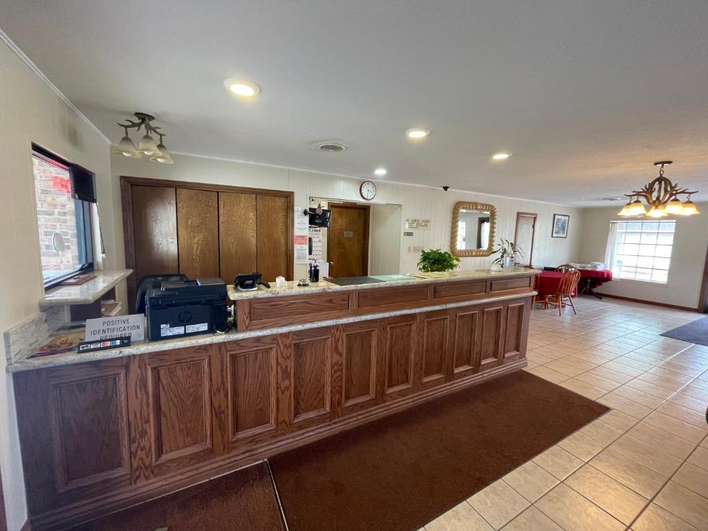 a large kitchen with a large island in a room at Village Inn in Ada