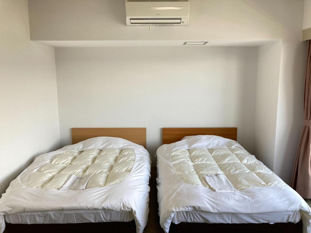 Postel nebo postele na pokoji v ubytování Chateraise Lodge Kasugai