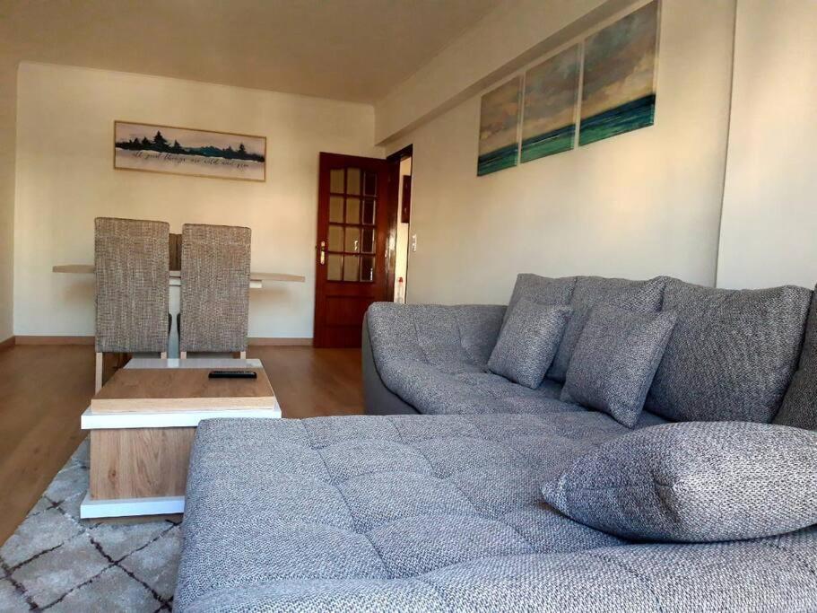 a living room with a couch and a table at Amazing Apartments in Agualva