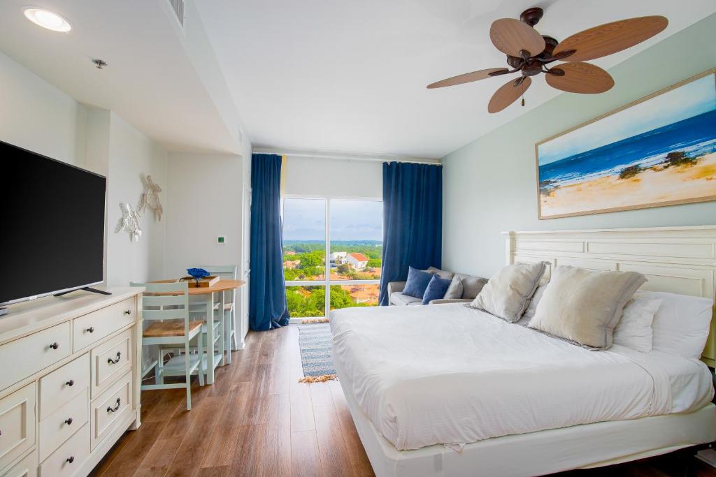 a bedroom with a bed and a ceiling fan at Luau 7012 in Destin
