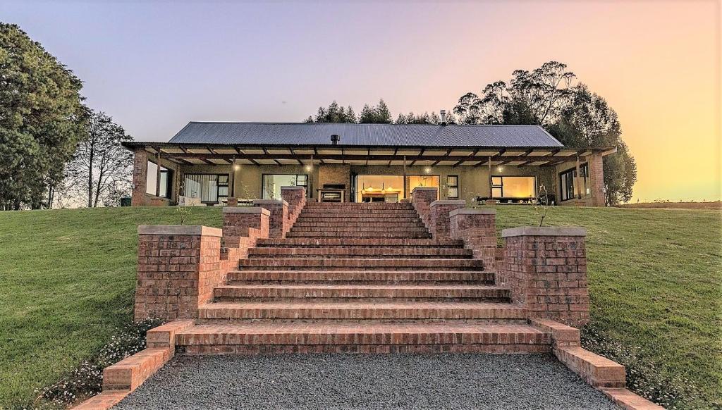 a house with stairs leading up to a building at Fairfax Cottage in Nottingham Road