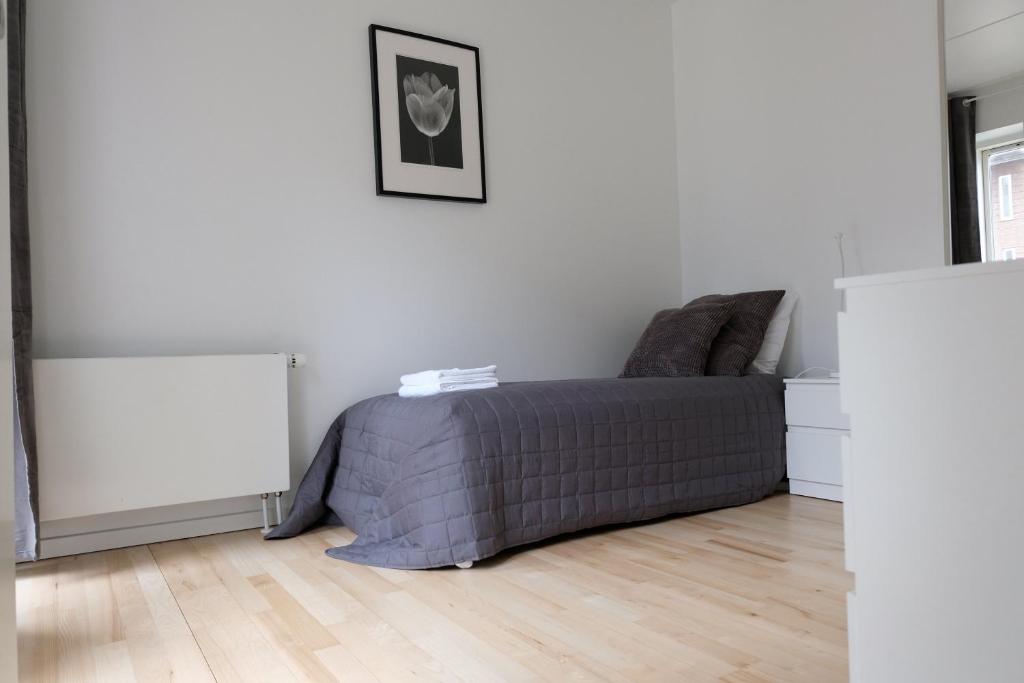 a bedroom with a bed in a white room at Three Bedroom Apartment In Copenhagen S, Cf Mllers Alle 56 in Copenhagen