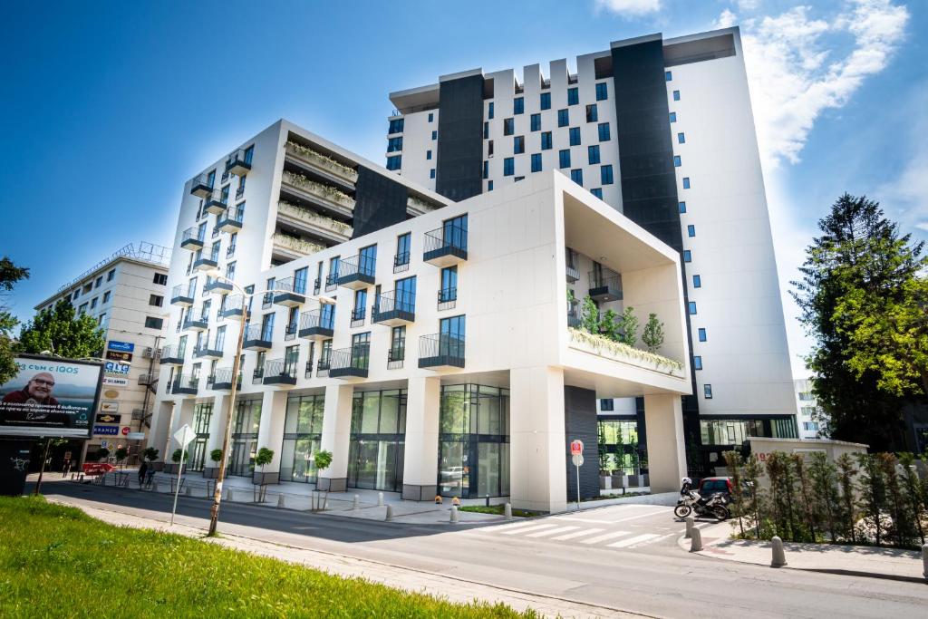 a large white building on a city street at Luxury Apartment Sea Garden- Building of the Year K55 in Varna City